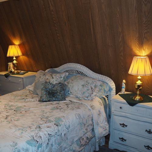 Bedroom:  includes a queen-size bed, dressers, night lamps, ceiling fan, closet, and room a/c unit.