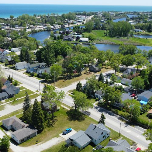 Overall:  aerial view of the house (at the bottom) with the au sable river, downtown oscoda, and lake huron in the background.