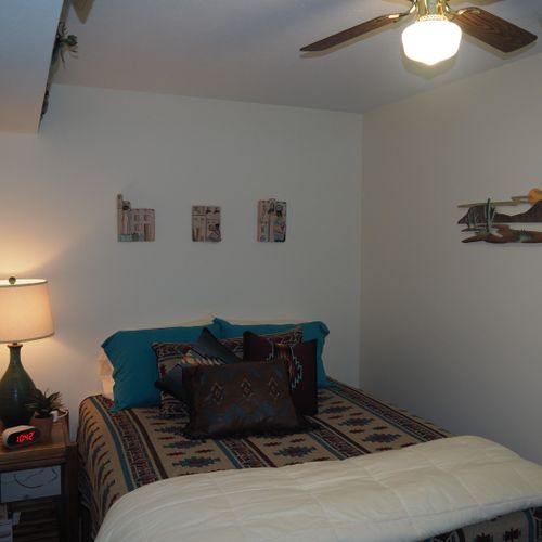 Bedroom:  very comfortable bedroom with a queen-size bed, ceiling fan, dresser, and mirror.