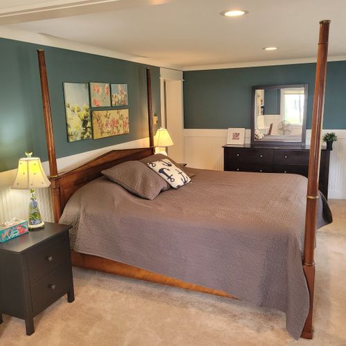 Bedroom #1 (larger house, main floor):  features a king-size bed, desk and chair, reading chair, and a huge en suite private full bathroom!