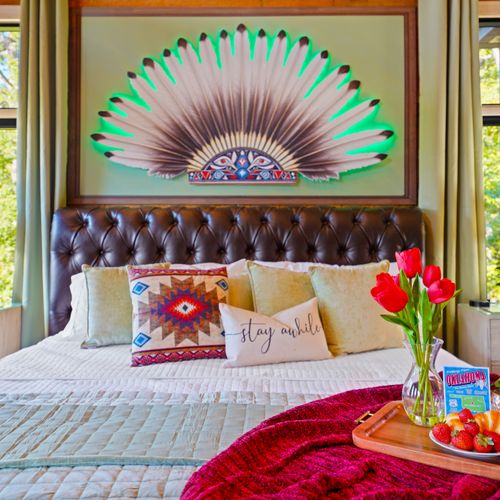 The illuminated headdress art above the bed adds a mesmerizing glow to this stunning themed sanctuary.