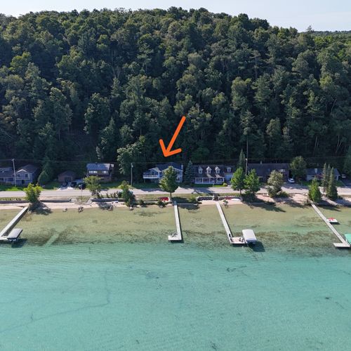 EXTERIOR:  A broader aerial view showing the beautiful colors of Crystal Lake along with the hills and trees that are behind the cottage.