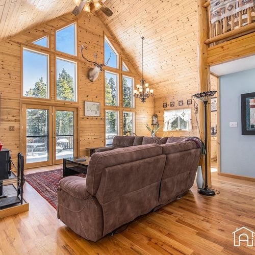 - floor to ceiling windows showcase the forest views and flood the room with sunshine
- from wood tones to vaulted ceilings, this space is built for rustic comfort
- perfect mix of mountain charm and modern convenience in one central lounge