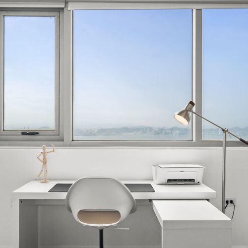 Bask in the natural light as you tackle the day's tasks in this sleek, minimalist home office.