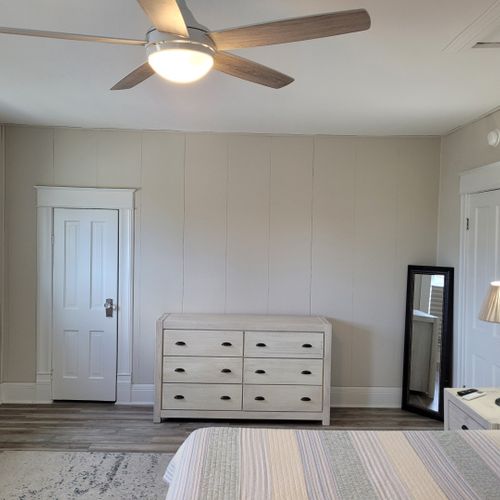 Bedroom #2 (second floor):  huge upstairs bedroom with a king-size bed, nightstands, lamps, 2 dressers, private television with live streaming, mini-split a/c unit, ceiling fan, desk with chair, comfy chairs, and a closet.