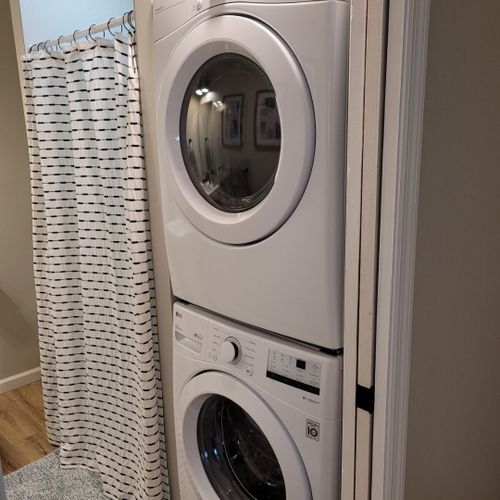 Bathroom #2:  second full bathroom that also serves as the laundry room having a stacked washer and dryer in it.