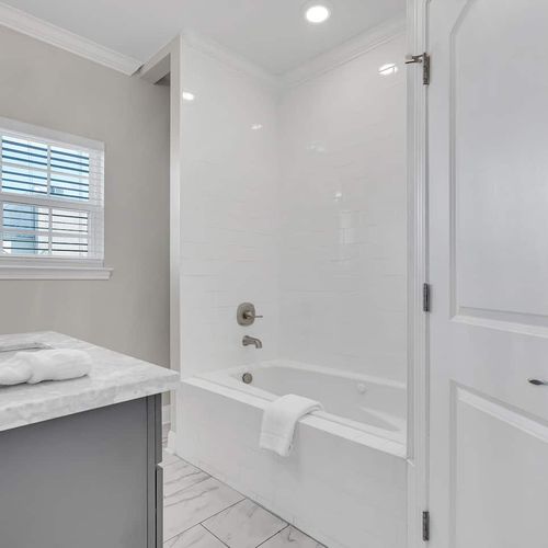 Primary bathroom featuring a tub & shower combo for a relaxing soak or rinse.