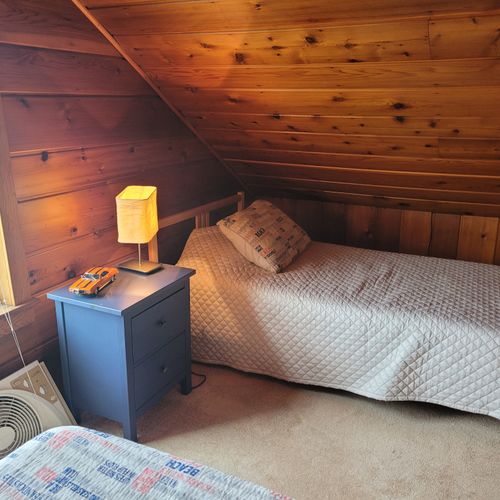 Bedroom #4 (larger hosue, second floor):  this is a large private area with its own sectional sofa, television, desk, and two twin beds.