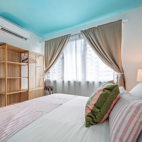 Retreat to this serene bedroom with a comfortable king-sized bed.