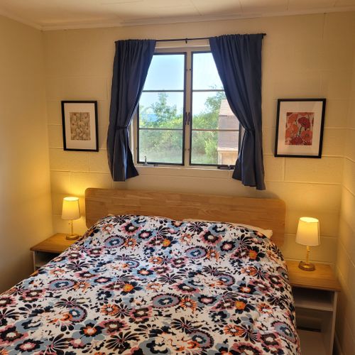 Bedroom #1:  features a queen-size bed, nightstands, lamps, mirror, and closet.
