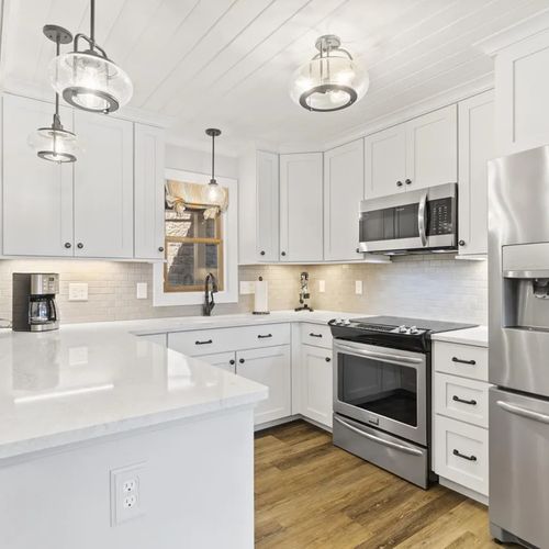 KITCHEN (MAIN FLOOR):  The home has a beautiful modern kitchen with all appliances (including a dishwasher) and a good supply of cooking and dining utensils