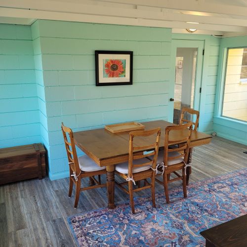 Sunroom:  the cottage has a very fun and family-friendly sunroom with a dining / game table, sofa, comfy chair, and a great view of crystal lake