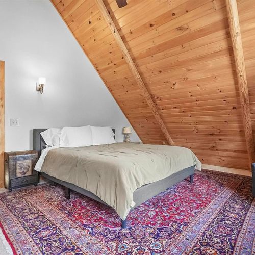 Bedroom #2 (second floor):  features a king-size bed, chair, dresser, ceiling fan, closet, and nightstand.