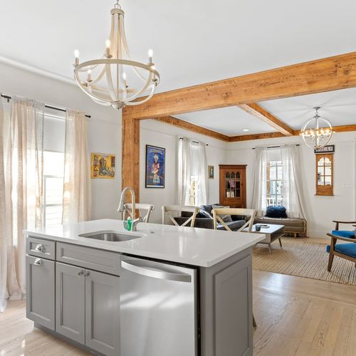 Warm living space w/ chandelier, comfortable seating & a welcoming layout.