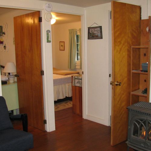 Living room:  the cabin has a cute little living room with a loveseat, dining table, and streaming television.