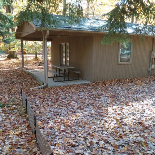 Exterior:  the back of the cabin, showing the private back porch and picnic table