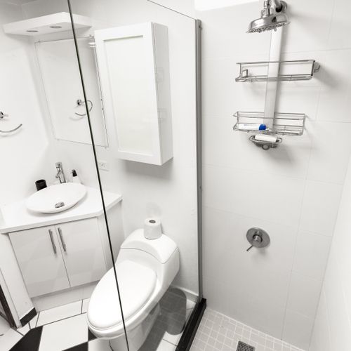 Refresh and rejuvenate in the sleek and modern bathroom. Enjoy a luxurious rain shower, convenient organizers for your toiletries, and a stylish stainless steel faucet, all designed for your comfort and convenience