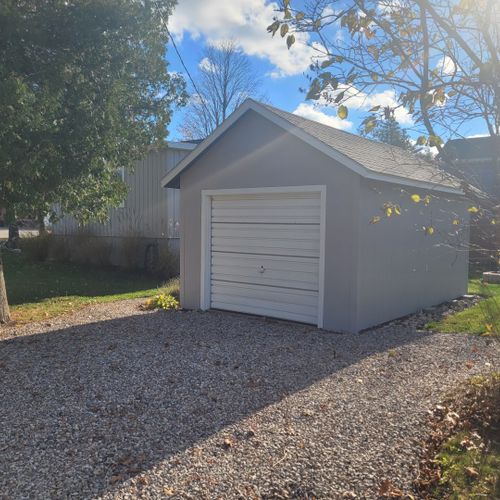 Exterior:  the detached garage (not available for guest usage) and the small  driveway.