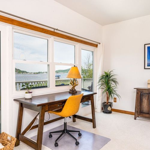 Living room:  the home has a large and lovely living room with comfy furniture, a gas fireplace, a desk, a large television with free living streaming, and great views of betsie lake!