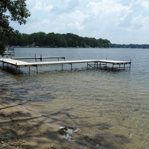 Exterior:  another view of the private dock, beach area, and sandy and shallow lake bottom near the shore.