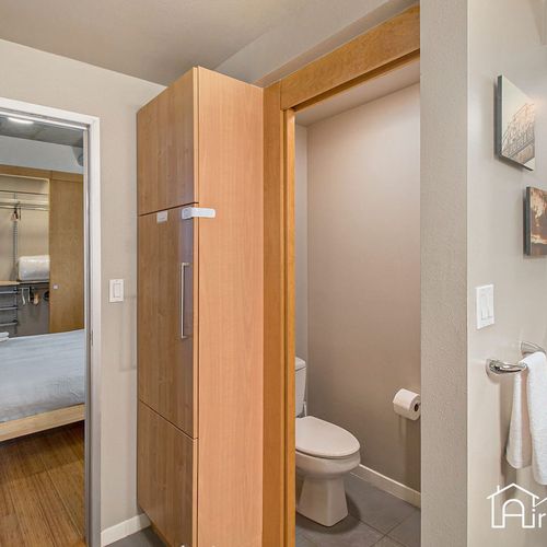 - secondary bathroom setup with private toilet space tucked just off the bedroom
- tall built in storage keeps essentials organized and within easy reach
- ideal for sharing the space while maintaining privacy and comfort