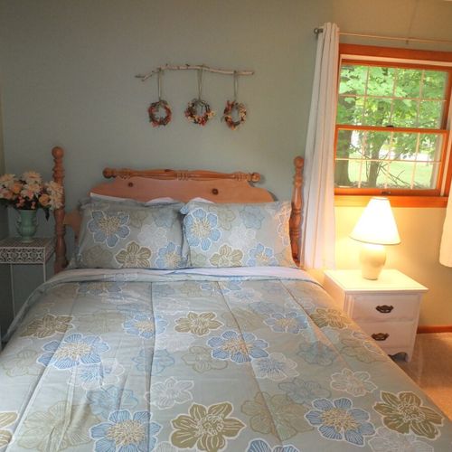 Bedroom #2: features a full-size bed, chair, nightstand, lamp, dresser, and closet.