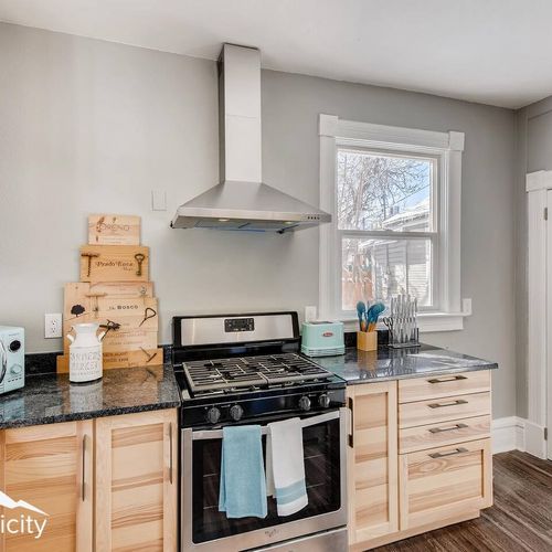 - stainless steel gas stove with modern vent hood is ready for home cooked meals and baking
- decorative cutting boards and mint kitchen accessories provide a cheerful pop
- drawers and cabinets offer ample storage for all your cooking needs