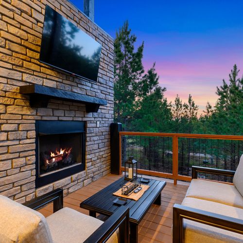 The gas fireplace and smart tv on the covered deck.