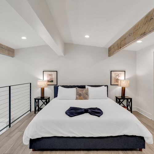 Spacious upstairs bedroom w/ stylish furnishings & a welcoming feel.