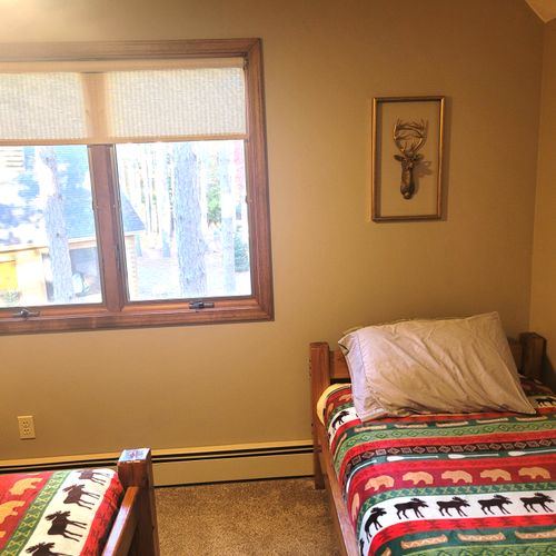 BEDROOM #4 (SECOND FLOOR):  Cute room with 2 twin beds, closet, dresser, and a lamp.