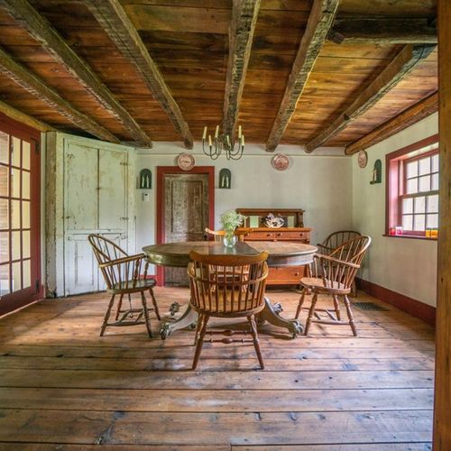 Dining room off of living area and kitchen with old wood beams
