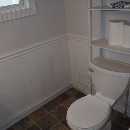 Bathroom #1  (downstairs):  the downstairs has a convenient half-bath next to the laundry room. It has a toilet, pedestal sink, and mirror.