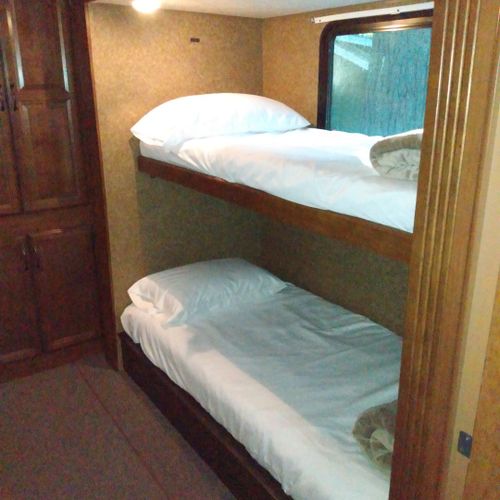 Bedroom #2:  includes 3 twin beds, a dresser, and a television.