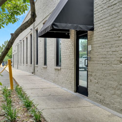 Inviting stone exterior w/ lush greenery framing the entrance.