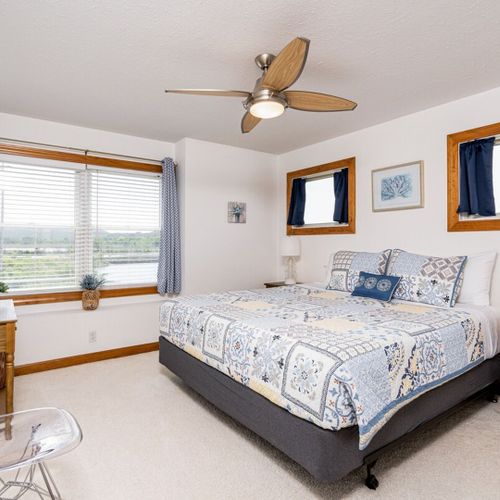 Bedroom #3 (second floor):  features a king-size bed, dresser, closet, ceiling fan, and great views of betsie lake!