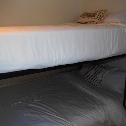 Bedroom #3:  features a queen-on-queen bunk bed, two cozy chairs that fold out into beds, a dresser, closet, and its own private television.