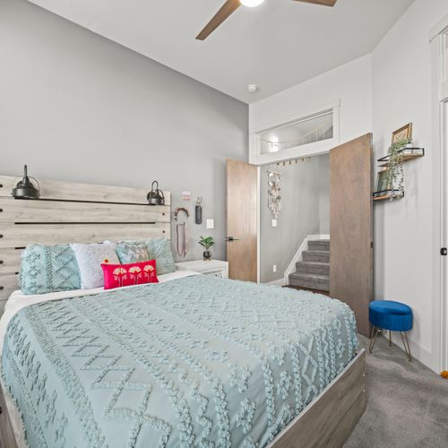Spotless, calming bedroom featuring plush bedding, thoughtful design, and peaceful ambiance throughout