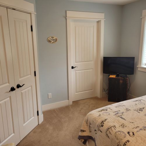 Bedroom #2 (larger house, main floor):  features a queen-size bed, closet, television, and its own private en suite full bathroom.