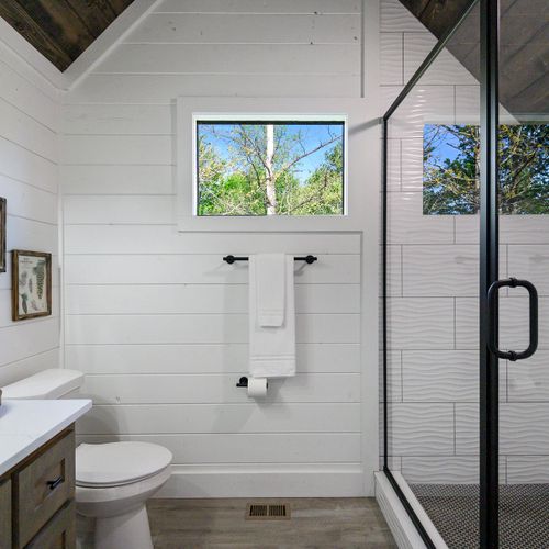 The full bathroom for the second floor to share featuring a walk-in shower.