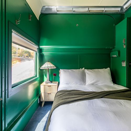 The Adirondack Suite equipped with a closet, bedside table, robes and slippers.