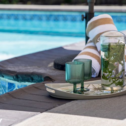 Poolside refreshments and relaxing atmosphere create the perfect vacation moment.
