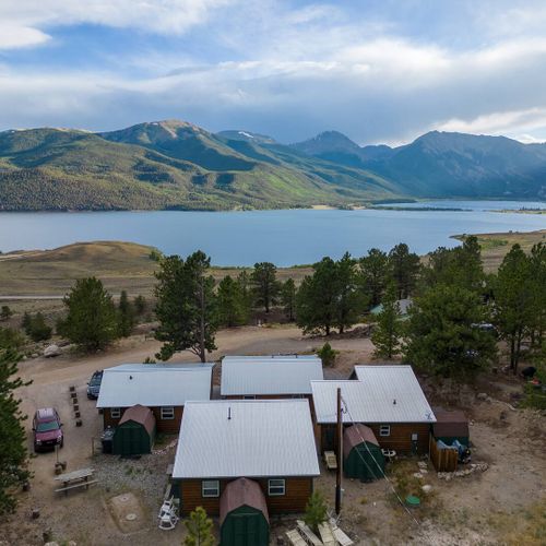 - breathtaking panoramic view of the lake backed by majestic green mountains
- nestled among tall pines, these rustic cabins offer a peaceful mountain escape
- just steps from nature with hiking, kayaking, and relaxing right outside your door