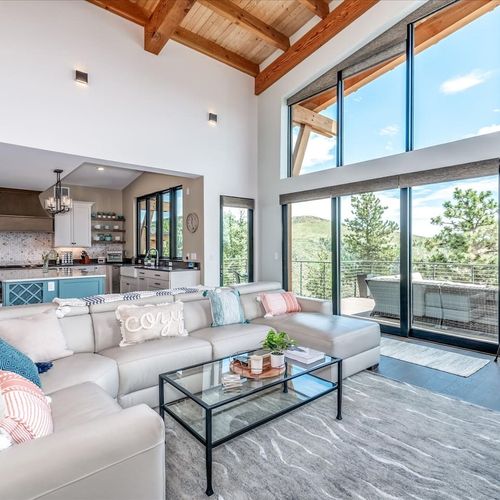 - soak in breathtaking mountain views through soaring floor to ceiling windows
- cloud soft sectional and cozy textiles create the perfect gathering space
- open design blends nature, comfort, and style in one seamless setting