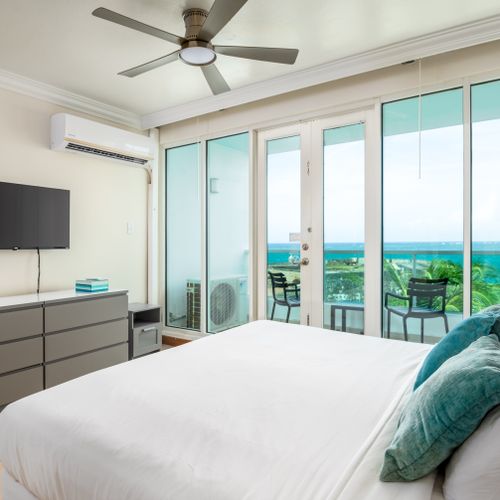 Wake up to paradise! Your luxurious King bed faces stunning ocean views, with direct access to your private balcony.