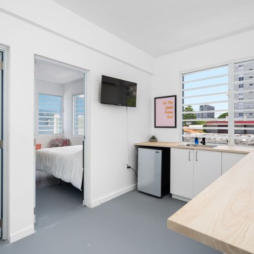 The juxtaposition of modern interiors with views of natural greenery offers guests a serene yet contemporary living experience.