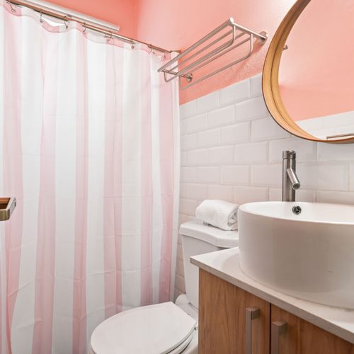 A clean and vibrant bathroom with modern design and a colorful touch.
