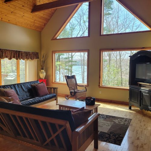 Living room:  gorgeous living room with 2 futons, an electric fireplace, and a lovely view of long lake!