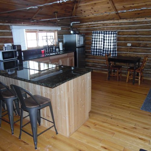 Kitchen:  a full view of the kitchen, with the small dining table in the background