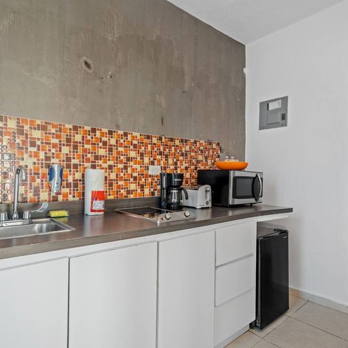 The modern appliances and clean, bright space make cooking a breeze. The colorful backsplash and modern appliances create a bright and cheerful atmosphere that is perfect for cooking and entertaining.