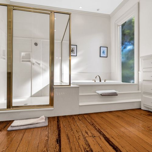 Spacious bathroom retreat with a luxurious walk-in shower and a serene soaking tub, perfect for unwinding.